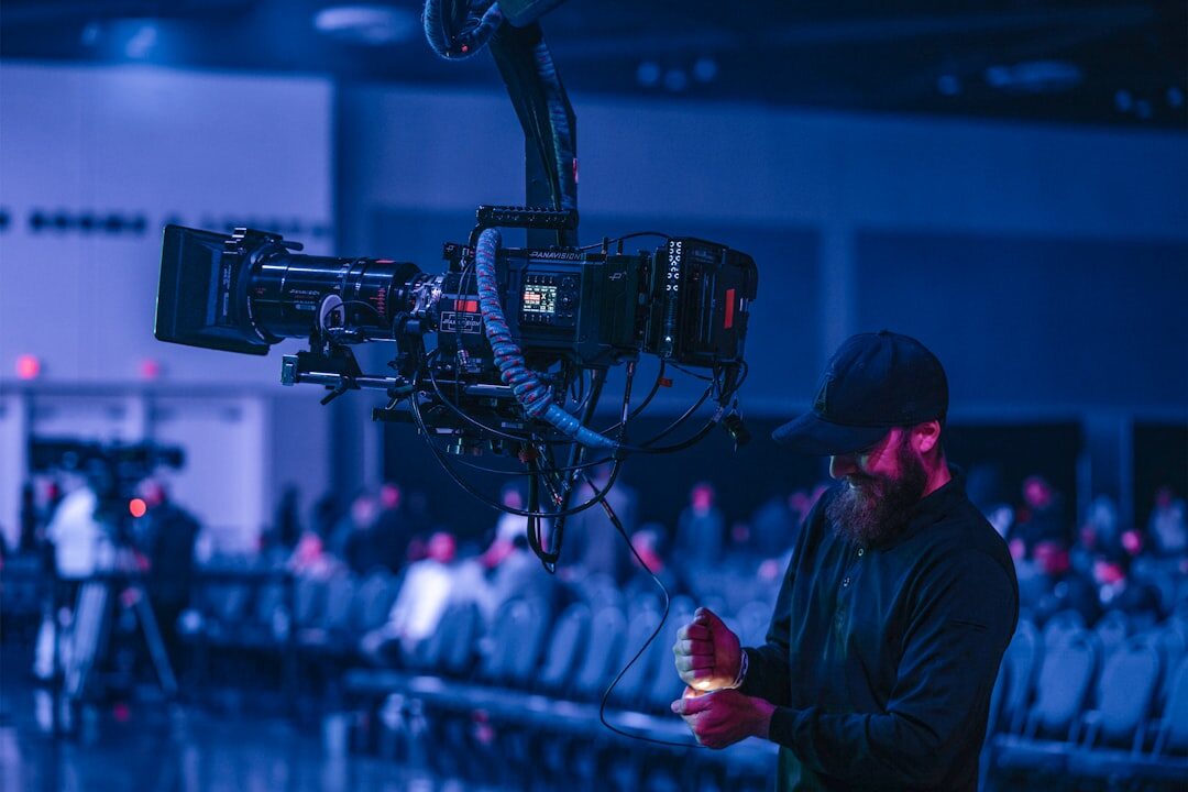 Technician adjusting a professional video camera at a conference